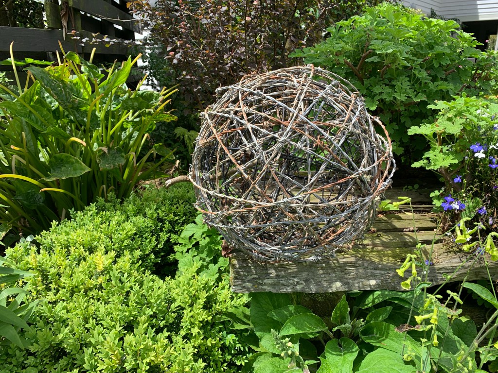 Decorative gsrfen sculpture created with barbed wire